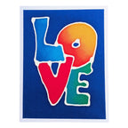 A hand painted pure silk original art card featuring the word LOVE in large colorful letters outlined in white on a dark blue background, with a white border around the print.