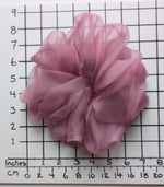 Load image into Gallery viewer, A dusty pink sheer PURE SILK ORGANZA OVERSIZED  scrunchie displayed on a white background with a black grid ruler showing inches and centimeters for scale.
