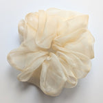 Load image into Gallery viewer, A large, voluminous sheer pure silk organza hair scrunchie in a soft cream or ivory color, displayed on a clean white background.
