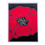 A HAND PAINTED PURE SILK ORIGINAL ART CARD GREETING  card featuring a stylized red poppy flower with a black center and dark background, shown against a plain white backdrop.