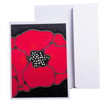 Load image into Gallery viewer, A HAND PAINTED PURE SILK ORIGINAL ART CARD greeting card with a large red poppy design on a black background, shown in front of a plain white envelope on a white studio backgrOUND
