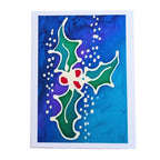 A hand painted pure silk original art card featuring a stylized holly design with green leaves, red berries, and white dotted accents on a blue and purple watercolor background
