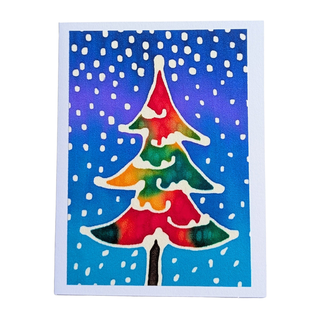 hand painted pure silk original art greeting card card featuring a stylized Christmas tree with a rainbow of red, orange, yellow, green, and blue tones, set against a blue and purple background with white snowflakes.