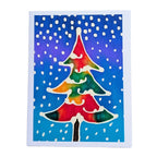 hand painted pure silk original art greeting card card featuring a stylized Christmas tree with a rainbow of red, orange, yellow, green, and blue tones, set against a blue and purple background with white snowflakes.