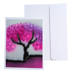 A hand painted pure silk original art greeting card with an abstract tree design featuring pink and purple circular leaves on a black trunk, shown next to a white envelope 