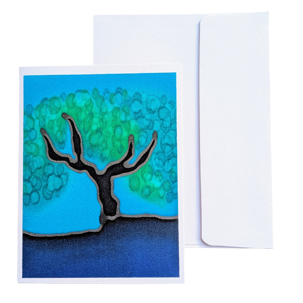 A hand painted  pure silk art card  greeting card with a stylized tree illustration in blue, green, black, and dark blue, shown in front of a plain white envelope 
