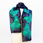 Load image into Gallery viewer, silk scarf hand painted green butterfly design art on black scarf made by Lynne Kiel
