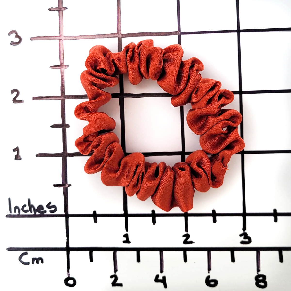 Skinny size scrunhie hair tie rust orange color pure silk handmade by Lynne Kiel