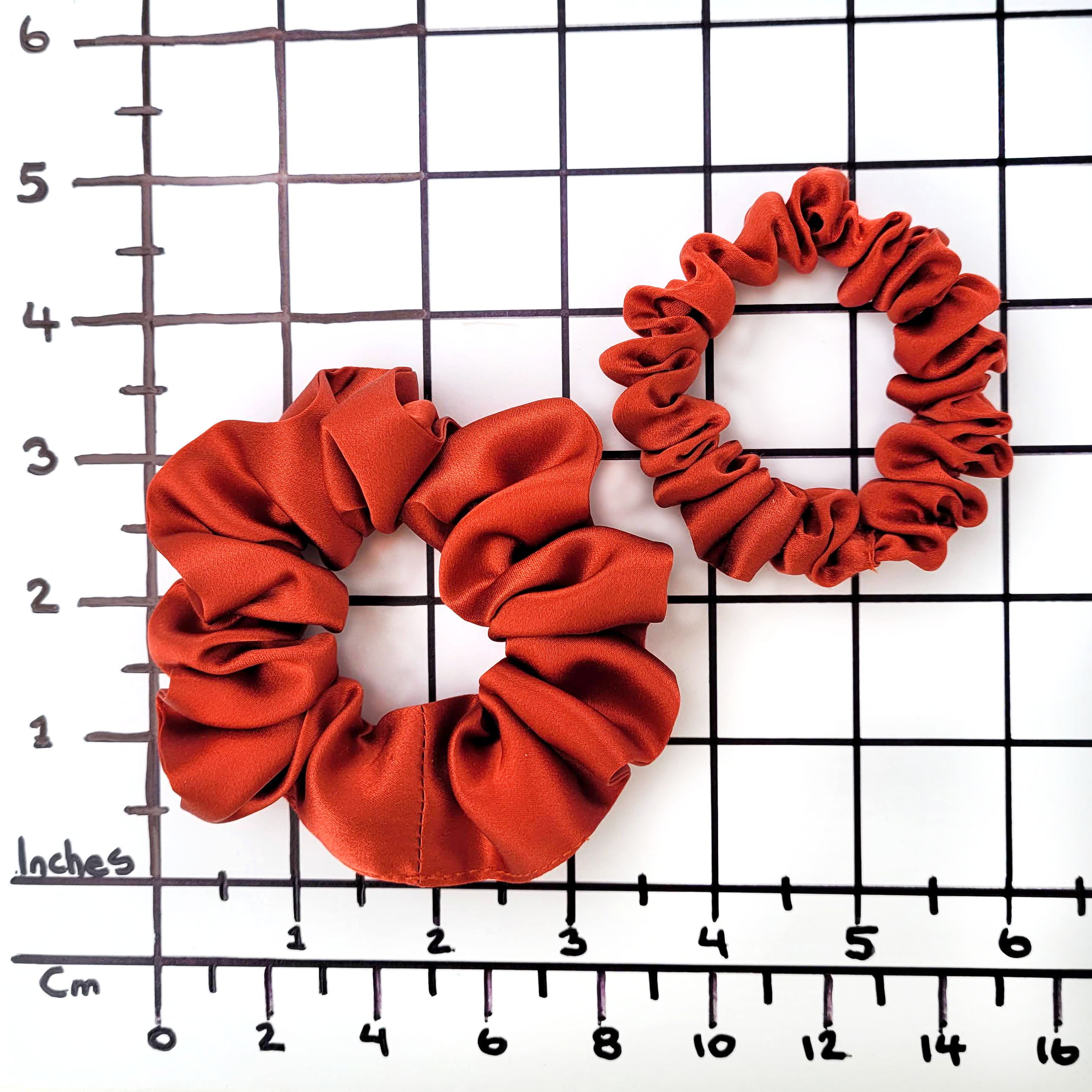 small and skinny pure silk scrunchie hair tie rust orange color handmade by Lynne Kiel