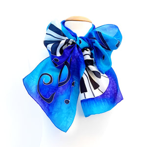 hand painted silk blue piano scarf tied in a bow blue turquoise purple colors